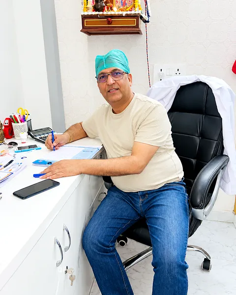 Dr. Chaturvedi smiling at his consultation desk
