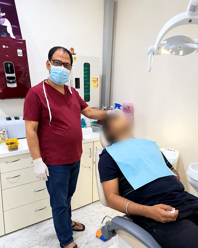 Dr. Chaturvedi examining a patient in the dental chair